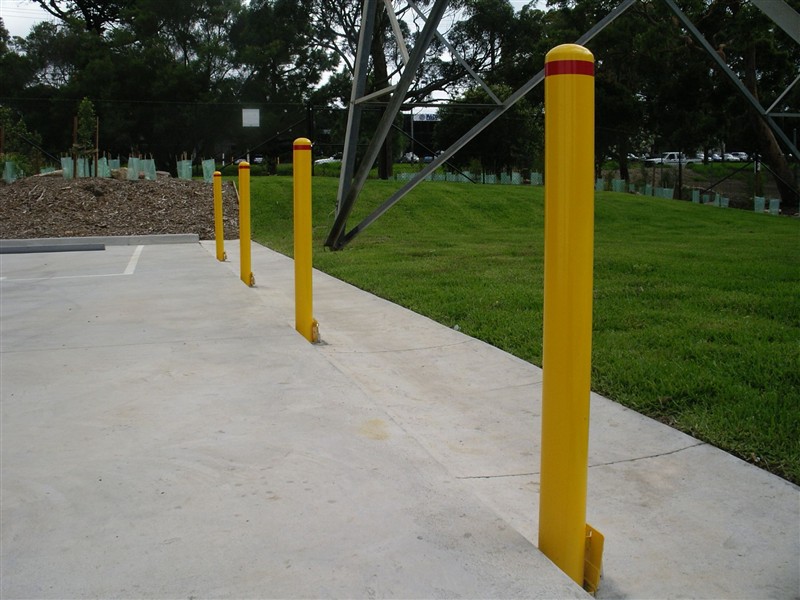 Removable yellow bollards along a carpark edge