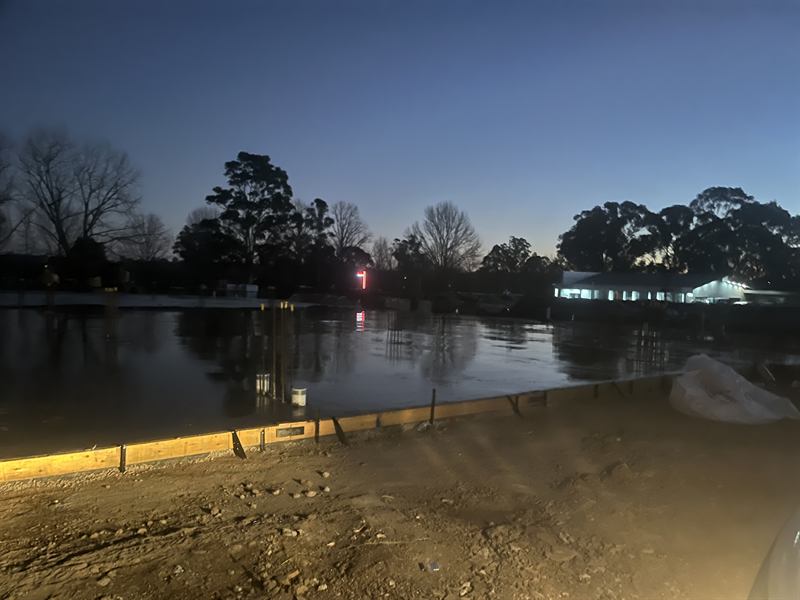 Curing compound applied to a slab edge in the early morning