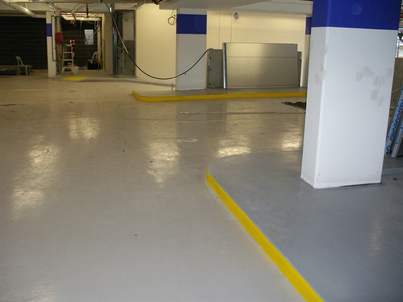 Epoxy carpark with painted columns and yellow kerbs