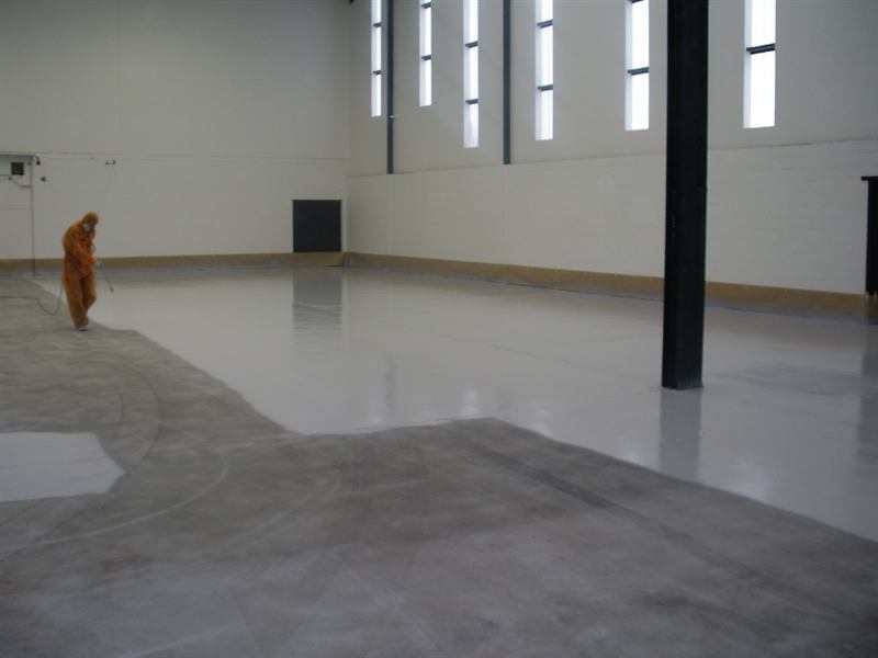 Spray-applying epoxy across the warehouse