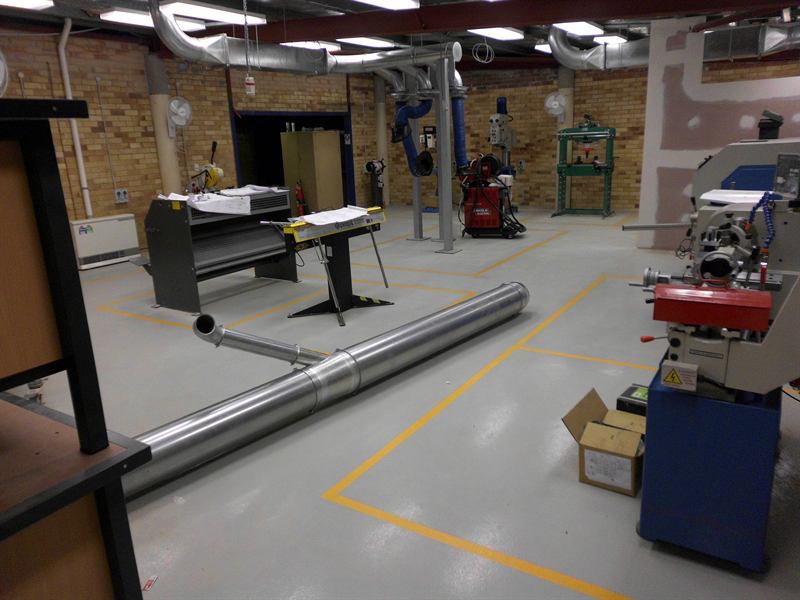 Tenterfield High School metal workshop in light grey epoxy with yellow machine zones
