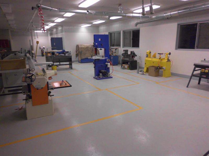 Workshop floor with white machine zone lines