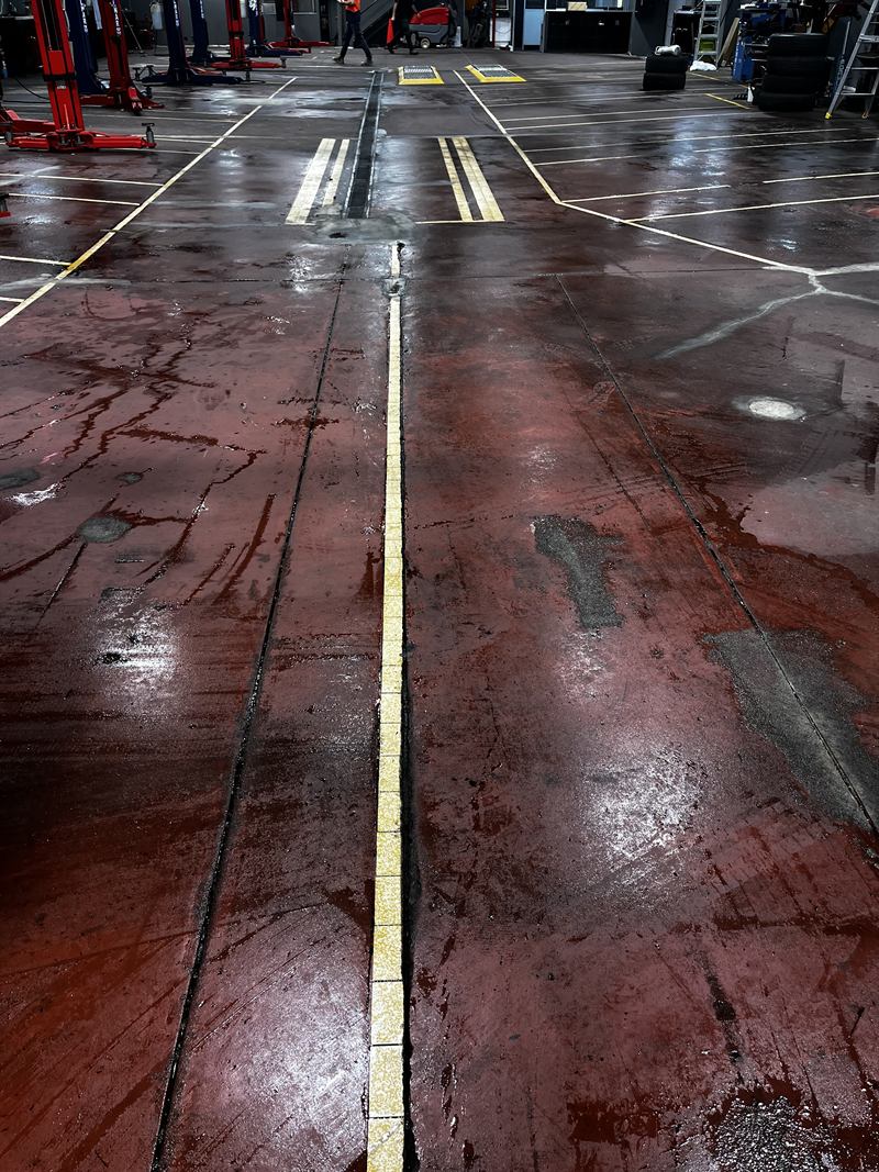 Workshop floor before: stained, worn concrete