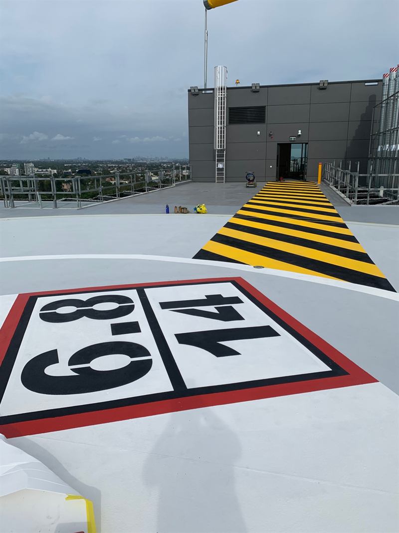 Weight marking and hazard-striped walkway to the rooftop door