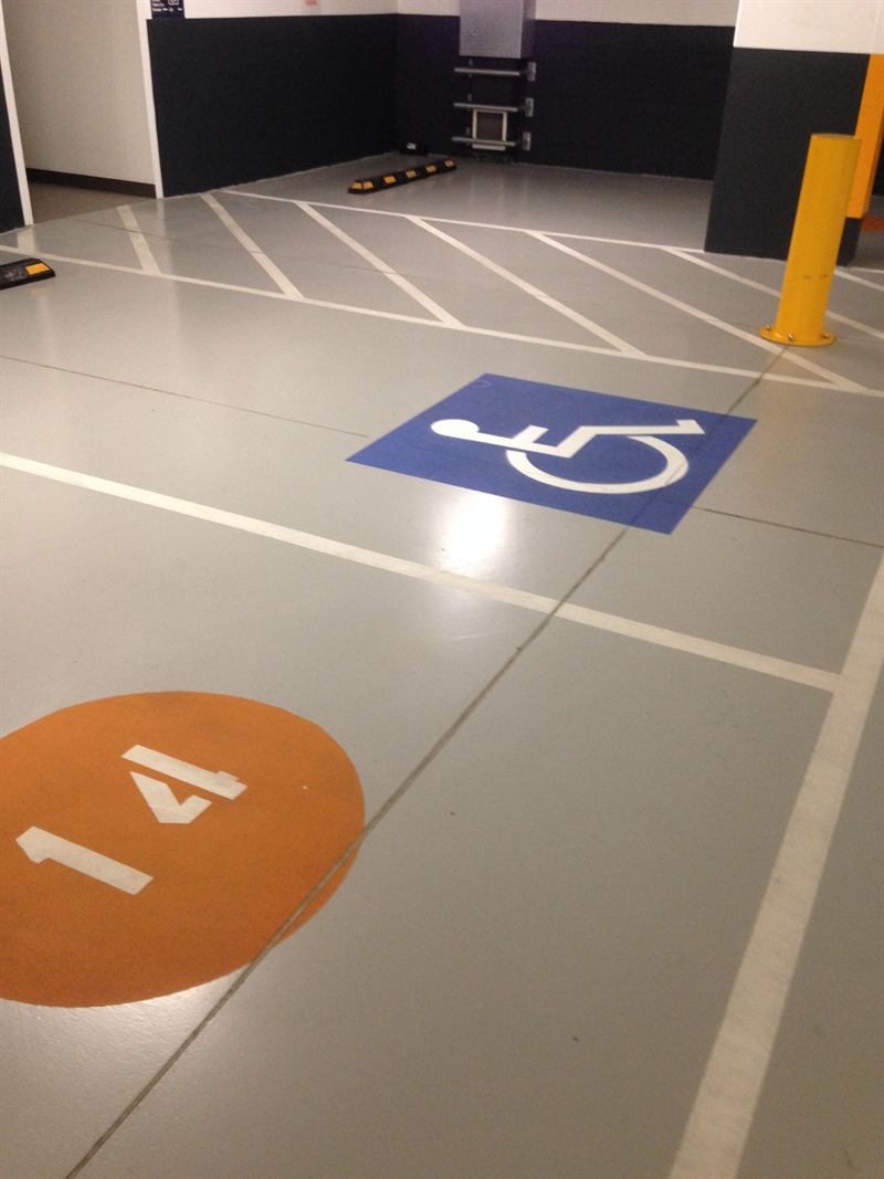 Numbered bay and disabled parking icon in an undercover carpark