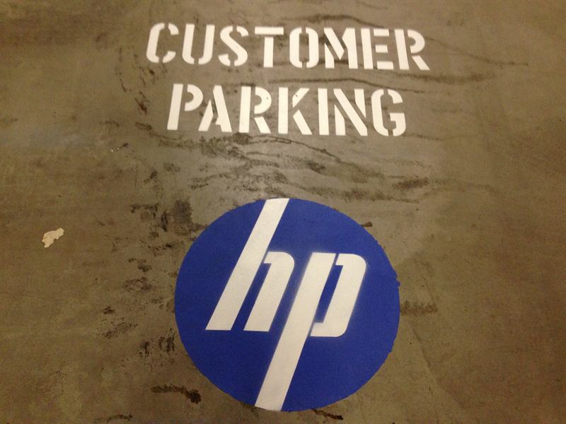 HP logo and customer parking stencil on a carpark bay