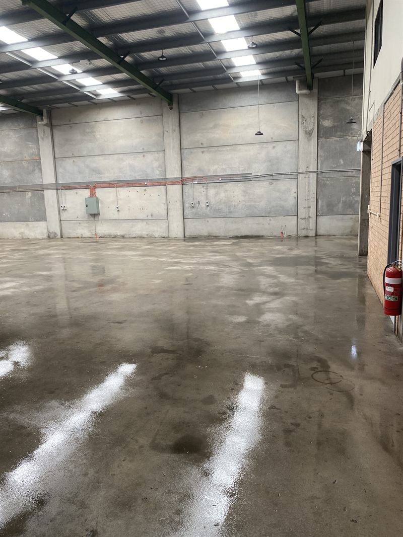 Clean warehouse floor after pressure cleaning, full length