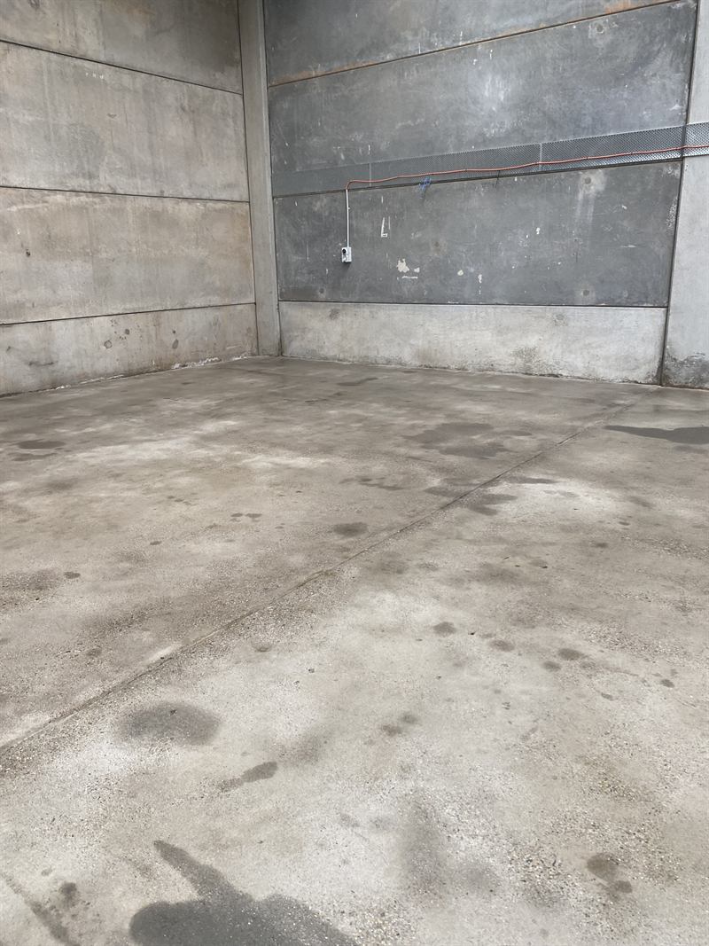 Warehouse floor before pressure cleaning